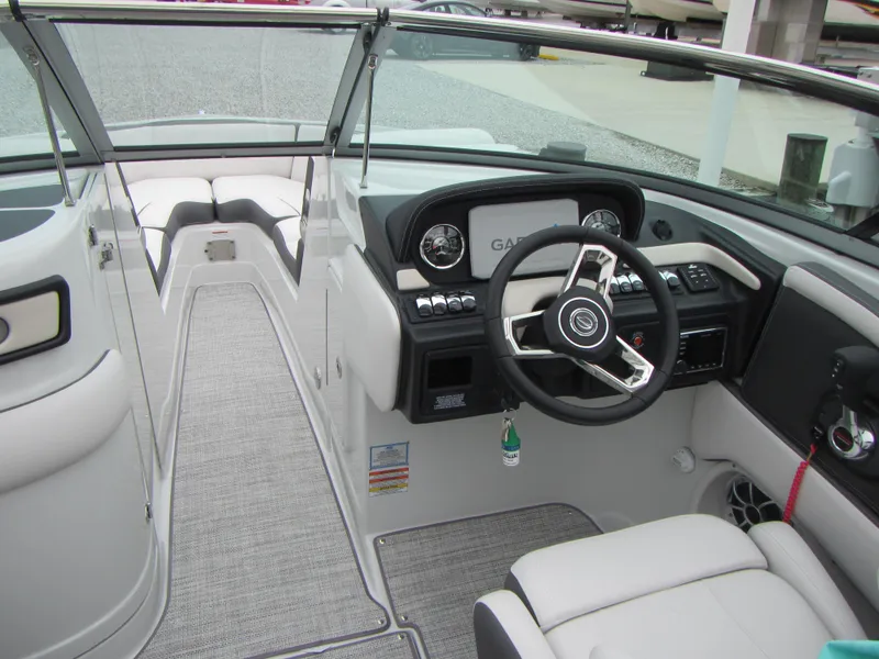 Slide: The Image of 2023 Crownline 270 SS boat interior with modern dashboard and steering wheel. - 5
