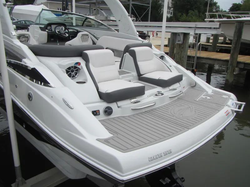 Slide: The Image of 2023 Crownline 270 SS boat with sleek design and comfortable seating at a marina. - 9