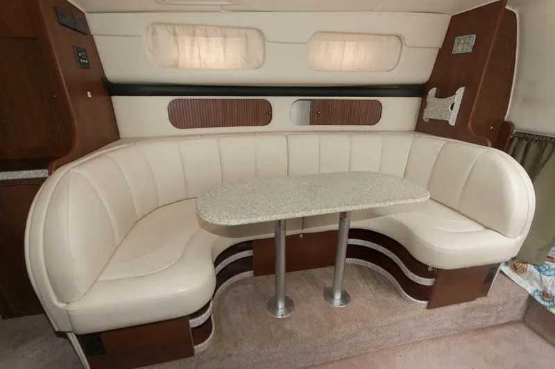 Slide: The Image of 2002 Rinker 342 Fiesta Vee interior with curved seating and table. - 10