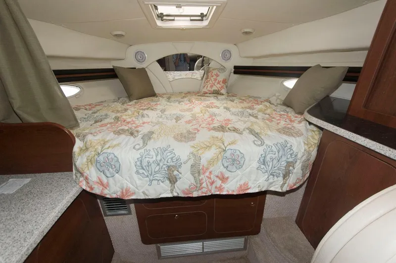 Slide: The Image of Cozy cabin interior of 2002 Rinker 342 Fiesta Vee with floral bedding and wood accents. - 13