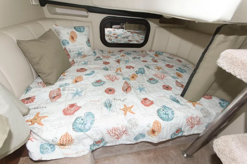Slide: The Image of Cozy cabin bed in 2002 Rinker 342 Fiesta Vee with nautical-themed bedding. - 14