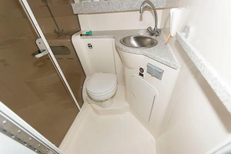 Slide: The Image of Compact bathroom in 2002 Rinker 342 Fiesta Vee boat with sink and toilet. - 15