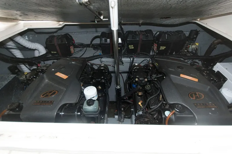 Slide: The Image of Engine compartment of 2002 Rinker 342 Fiesta Vee boat, featuring dual engines and batteries. - 16