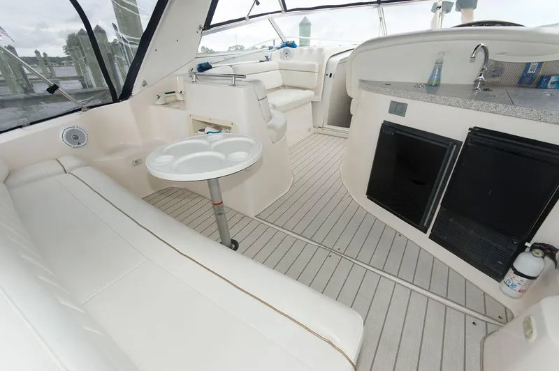 Slide: The Image of Interior of 2002 Rinker 342 Fiesta Vee yacht with seating and kitchenette. - 2