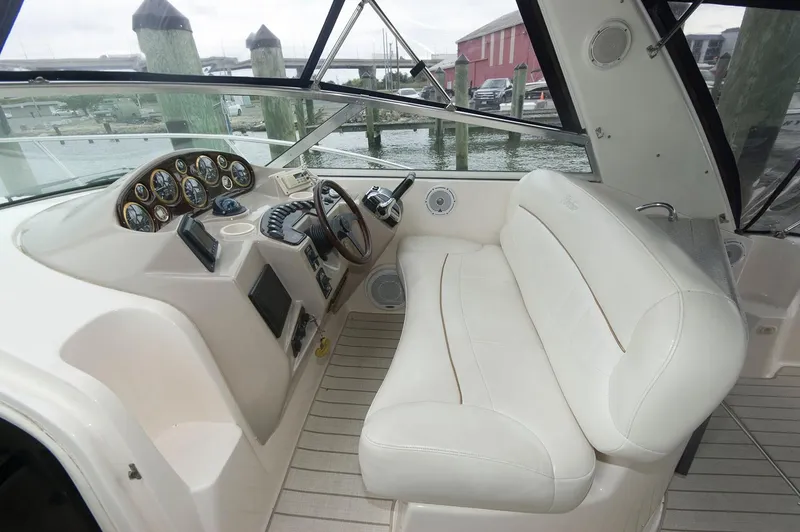 Slide: The Image of 2002 Rinker 342 Fiesta Vee boat interior with white seating and control panel. - 3