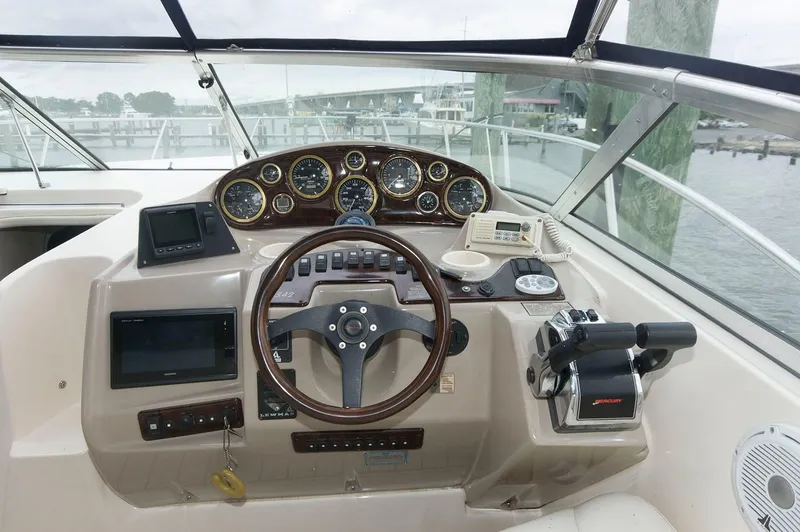 Slide: The Image of 2002 Rinker 342 Fiesta Vee boat dashboard with steering wheel and navigation instruments. - 4
