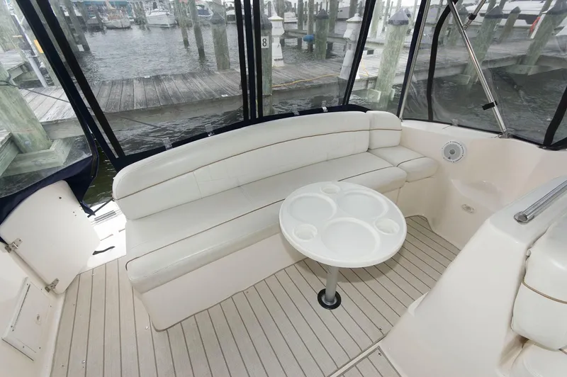 Slide: The Image of 2002 Rinker 342 Fiesta Vee boat interior with white seating and round table. - 5