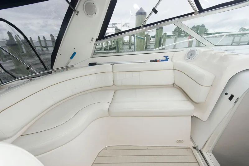 Slide: The Image of 2002 Rinker 342 Fiesta Vee boat interior with white seating and dock view. - 6