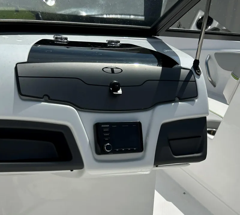 Slide: The Image of Dashboard of 2023 Tahoe 210 Si boat with control panel and storage compartment. - 4