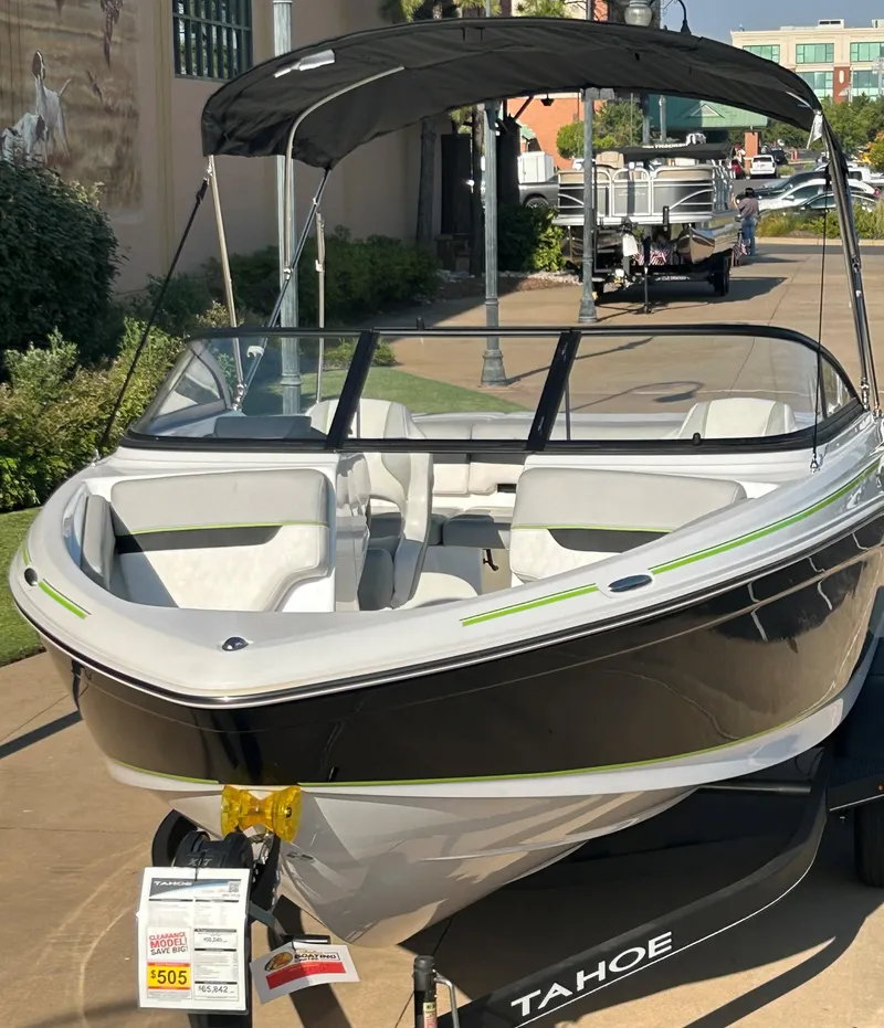 Slide: The Image of 2023 Tahoe 210 Si boat on display with canopy and trailer. - 6