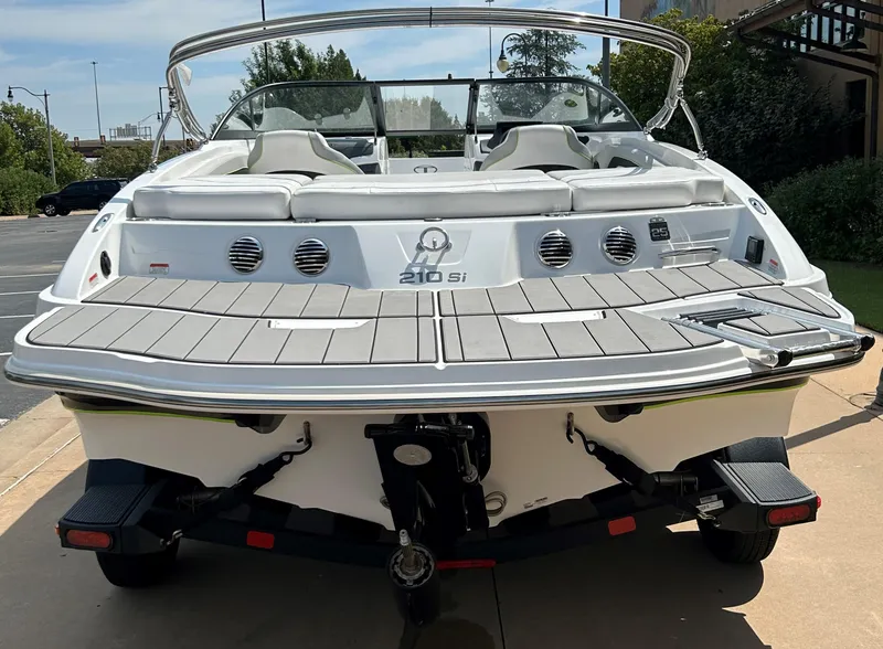 Slide: The Image of 2023 Tahoe 210 Si boat, rear view, docked on a sunny day. - 8