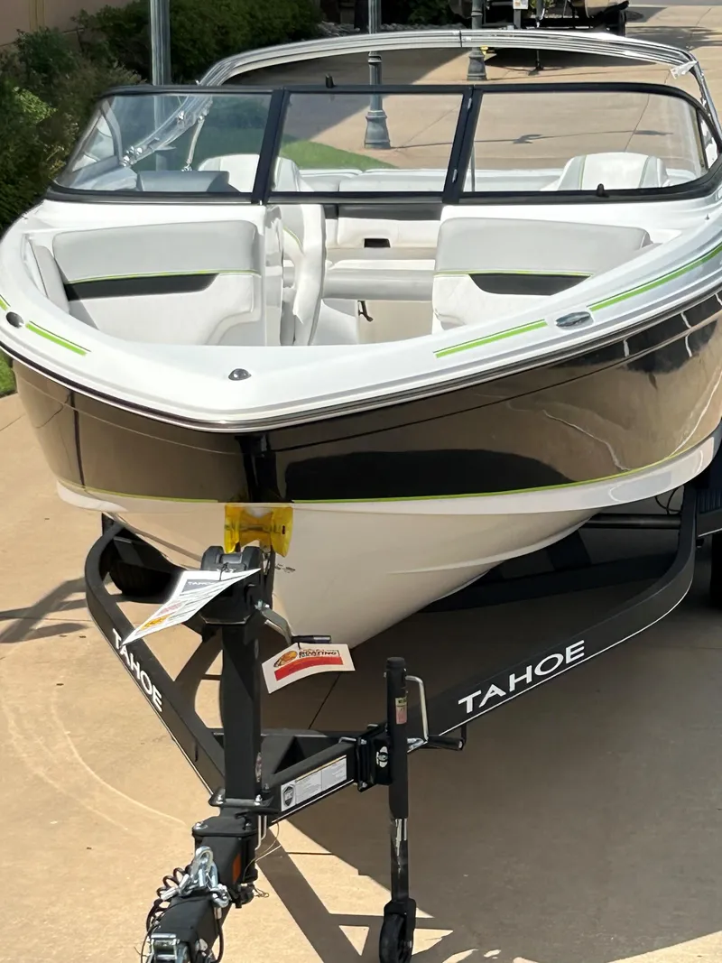 Slide: The Image of 2023 Tahoe 210 Si boat on a trailer, front view. - 9