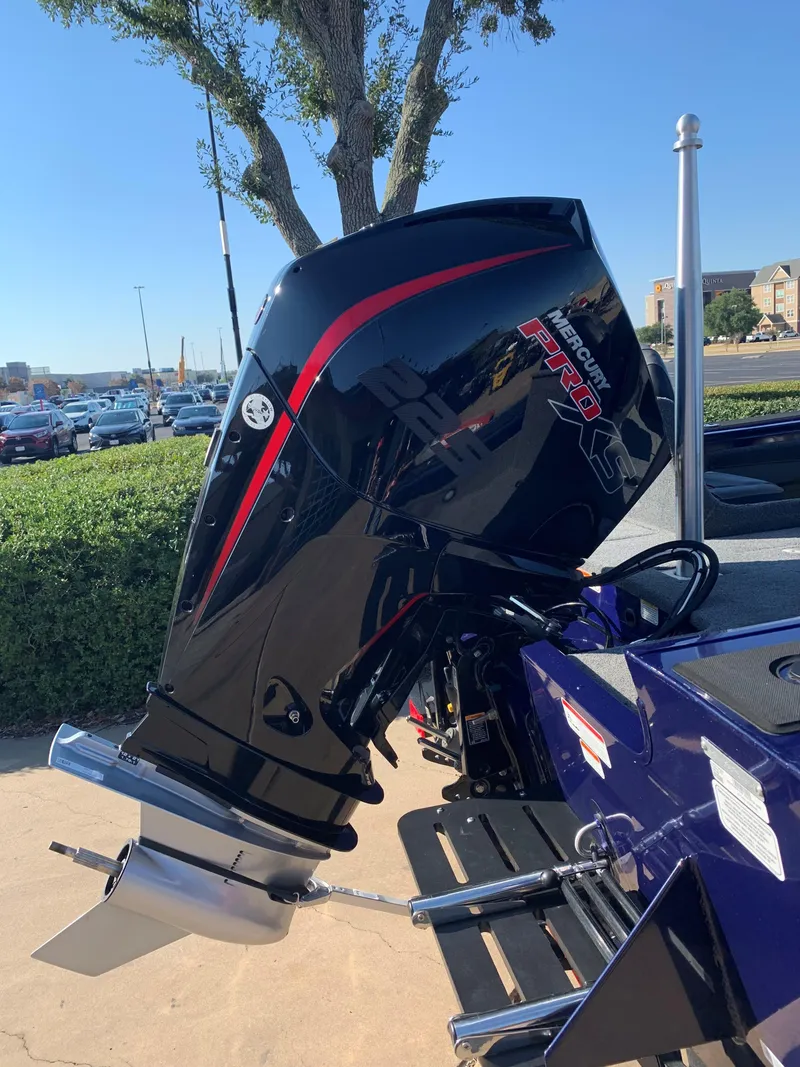 Slide: The Image of 2023 Tracker Targa V-19 WT boat with powerful outboard motor, parked outdoors. - 2