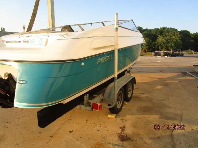 Slide: The Image of 1995 Regal VALANTI 222 SE boat on trailer, teal and white design, parked outdoors. - 1