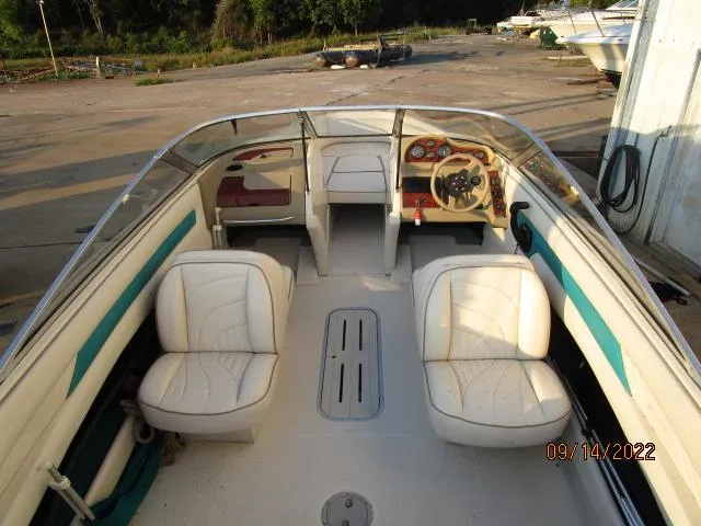Slide: The Image of 1995 Regal VALANTI 222 SE boat interior with white seats and steering wheel. - 4