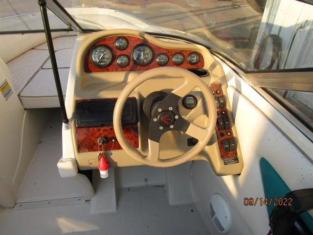 Slide: The Image of 1995 Regal VALANTI 222 SE boat dashboard with steering wheel and instrument panel. - 5