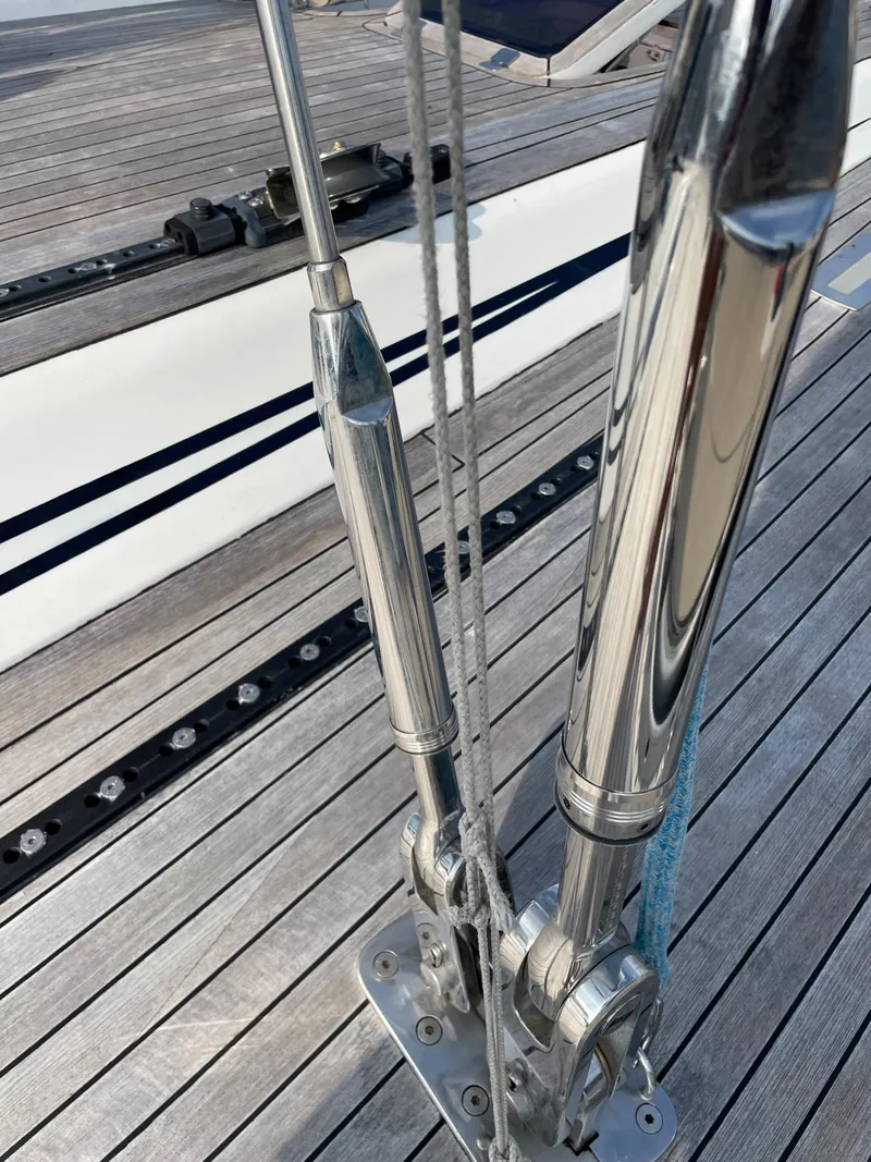 Slide: The Image of Close-up of Nautor Swan 68 yacht rigging, showcasing polished metal fittings and wooden deck, 1992 model. - 12
