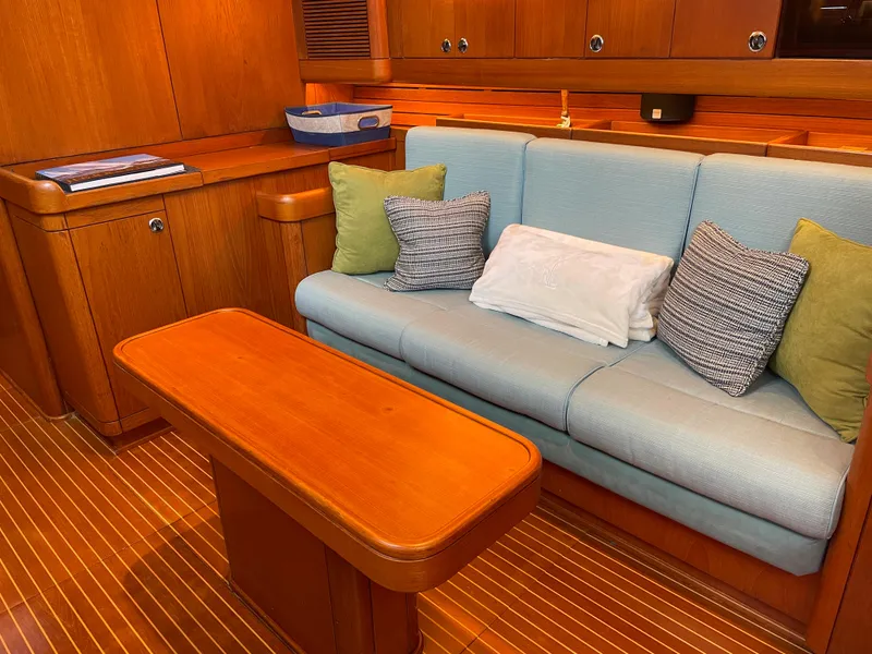 Slide: The Image of Interior of 1992 Nautor Swan 68 yacht with wooden table and cushioned seating. - 17