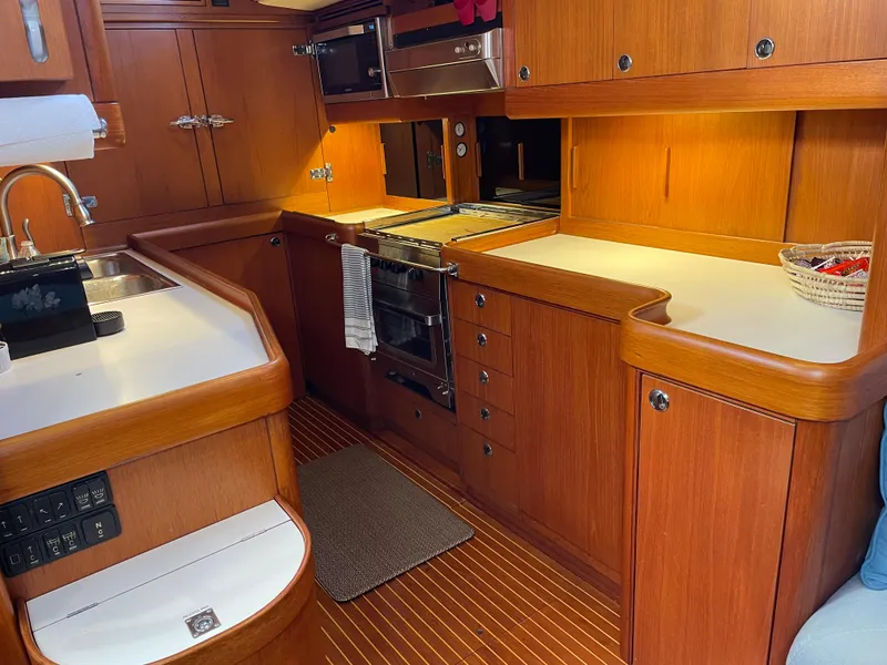 Slide: The Image of Interior kitchen of 1992 Nautor Swan 68 yacht with wooden cabinetry and modern appliances. - 18