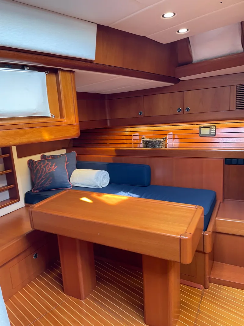 Slide: The Image of Interior of 1992 Nautor Swan 68 yacht with wooden furnishings and blue seating. - 20