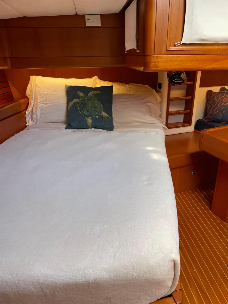 Slide: The Image of Cozy bedroom in a 1992 Nautor Swan 68 yacht with wooden interiors. - 21