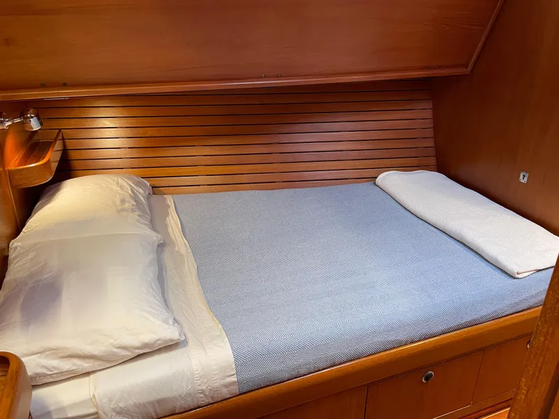 Slide: The Image of Cozy cabin bed in 1992 Nautor Swan 68 yacht with wooden paneling. - 23