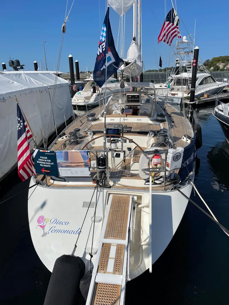 Slide: The Image of Nautor Swan 68 yacht, 1992 model, docked with flags and Disco Lemonade name. - 4