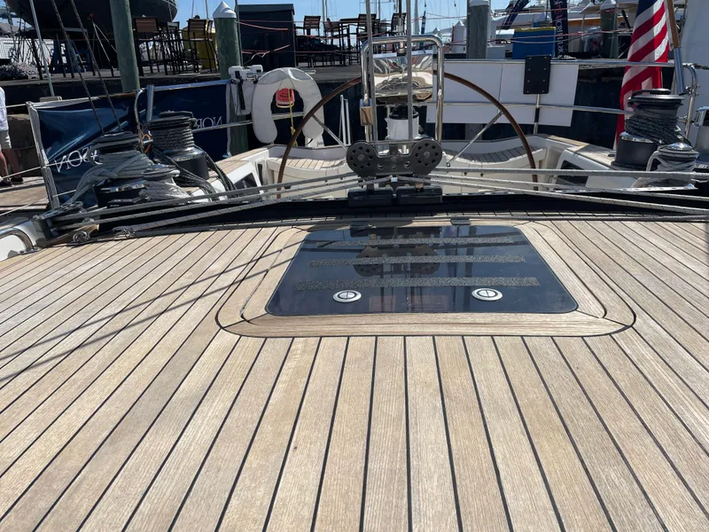 Slide: The Image of Nautor Swan 68 (1992) yacht deck with wooden finish and steering wheel. - 8