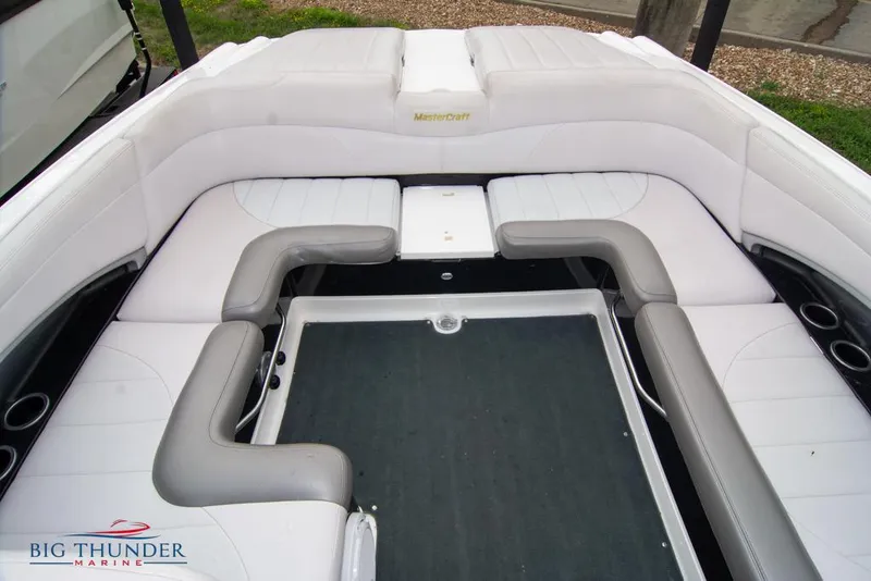 Slide: The Image of 2005 MasterCraft X45 boat interior with white and gray seating, Big Thunder Marine logo. - 19
