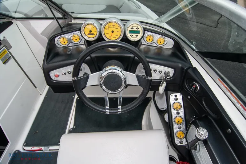 Slide: The Image of 2005 MasterCraft X45 boat dashboard with steering wheel and gauges. - 23