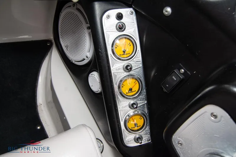 Slide: The Image of 2005 MasterCraft X45 boat dashboard with yellow gauges and speaker. - 30