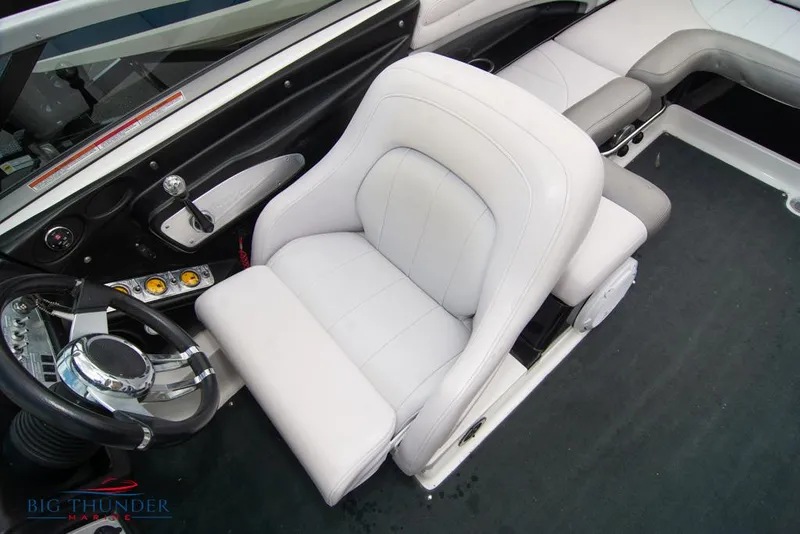 Slide: The Image of 2005 MasterCraft X45 boat interior with white captain's chair and steering wheel. - 36