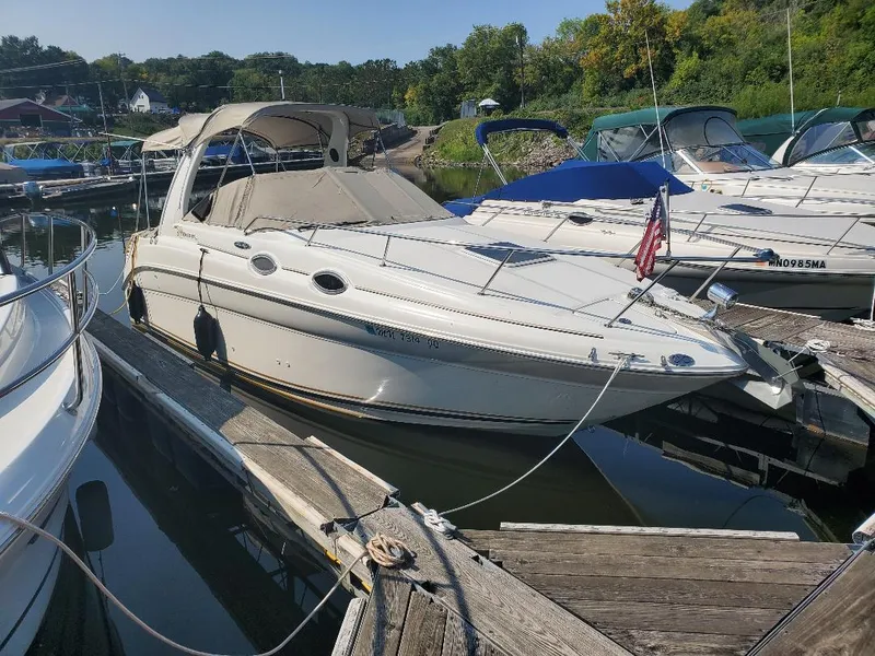 The Image of 2003 Sea Ray 260 Sundancer docked at a marina, surrounded by other boats. - 0