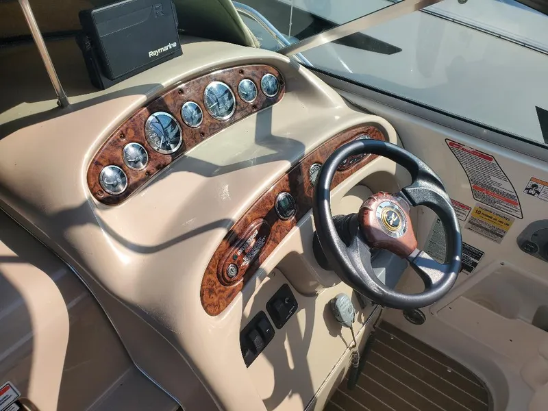 Slide: The Image of Dashboard of 2003 Sea Ray 260 Sundancer boat with steering wheel and gauges. - 11