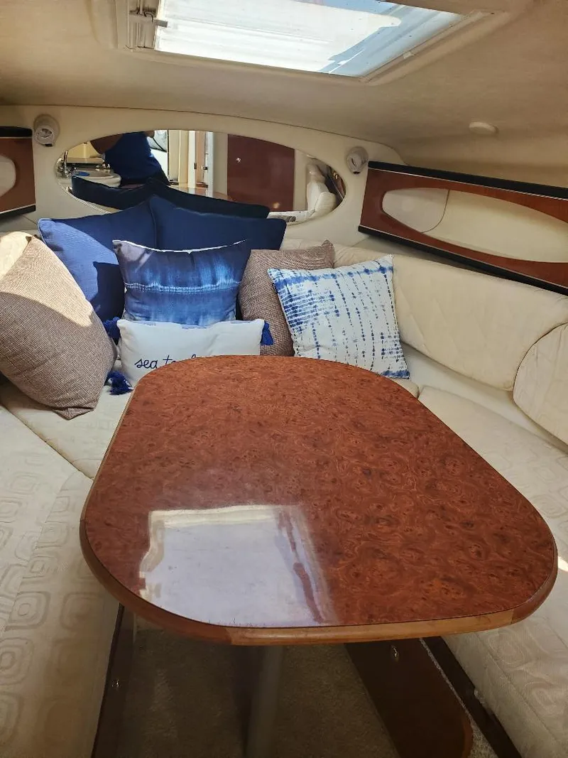 Slide: The Image of Interior of 2003 Sea Ray 260 Sundancer with cozy seating and decorative pillows. - 3