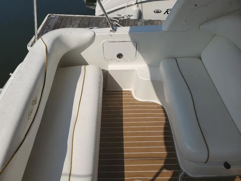 Slide: The Image of 2003 Sea Ray 260 Sundancer boat interior with white seating and striped flooring. - 7