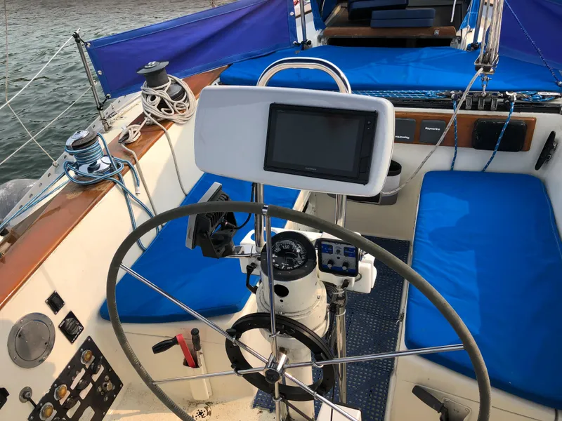 Slide: The Image of Cockpit of 1978 Palmer Johnson New York 40 Sloop with blue seating and navigation equipment. - 10