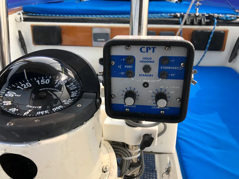 Slide: The Image of Cockpit instruments of a 1978 Palmer Johnson New York 40 Sloop, featuring compass and autopilot controls. - 12