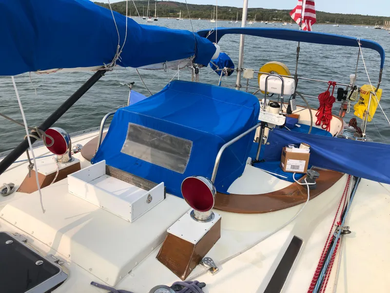 Slide: The Image of 1978 Palmer Johnson New York 40 Sloop with blue covers, docked on calm water. - 14