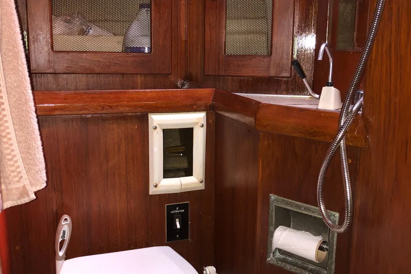 Slide: The Image of 1978 Palmer Johnson New York 40 Sloop bathroom with wooden cabinetry and showerhead. - 21