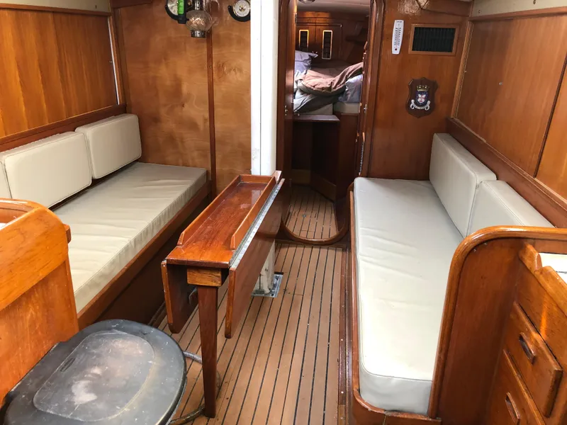 Slide: The Image of Interior of 1978 Palmer Johnson New York 40 Sloop with wooden furnishings and cushioned seating. - 4