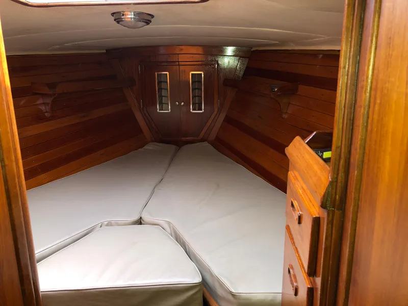 Slide: The Image of Interior cabin of 1978 Palmer Johnson New York 40 Sloop with wooden paneling and cushioned berth. - 6