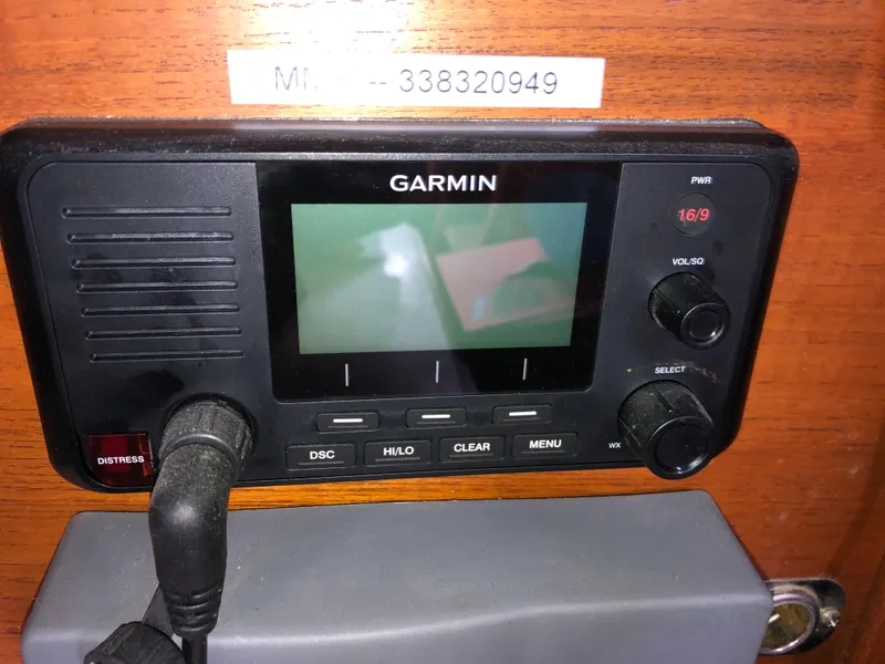 Slide: The Image of Garmin marine radio on 1978 Palmer Johnson New York 40 Sloop, wooden panel background. - 7