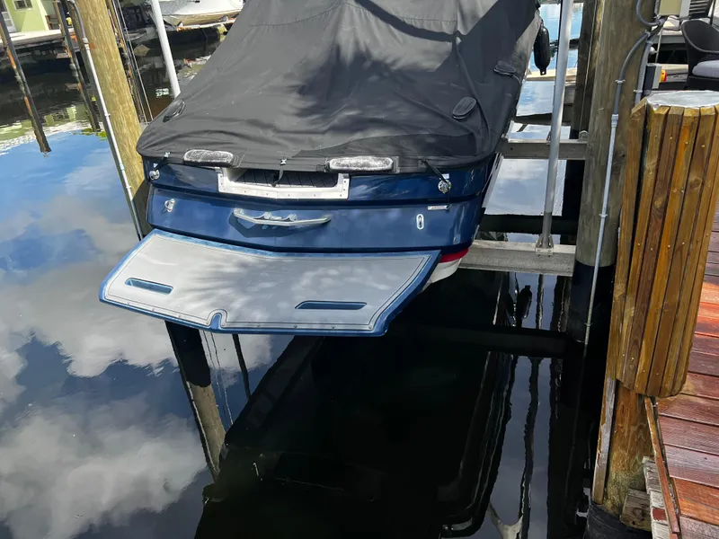 Slide: The Image of 2014 MasterCraft X-55 boat with cover, docked on a lift. - 1