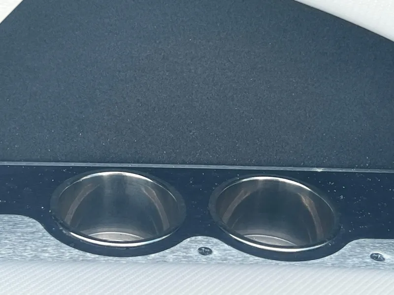 Slide: The Image of Close-up of cup holders in a 2014 MasterCraft X-55 boat. - 11