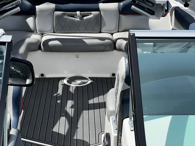 Slide: The Image of 2014 MasterCraft X-55 boat interior with gray seating and black flooring. - 12