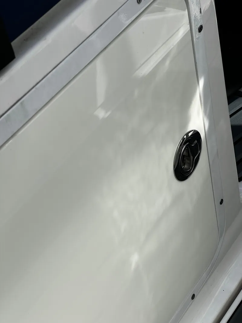 Slide: The Image of Close-up of a 2014 MasterCraft X-55 boat's white exterior panel with a chrome handle. - 15