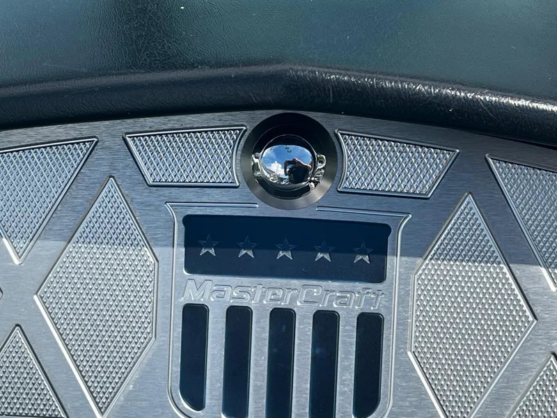 Slide: The Image of Close-up of 2014 MasterCraft X-55 logo on metallic surface. - 17