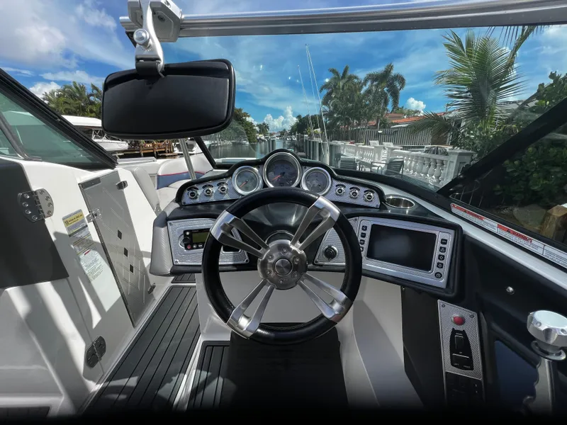 Slide: The Image of 2014 MasterCraft X-55 boat dashboard with steering wheel, gauges, and touchscreen display. - 25