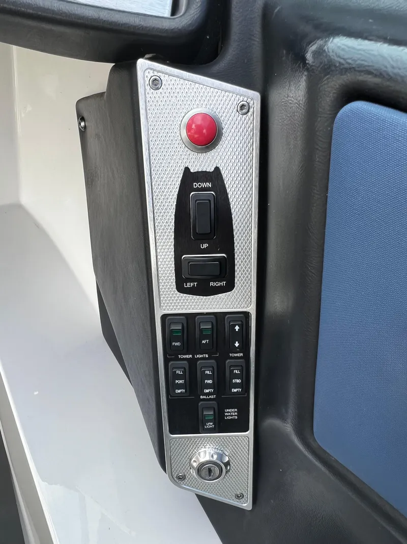 Slide: The Image of Control panel of a 2014 MasterCraft X-55 boat with various switches and buttons. - 27